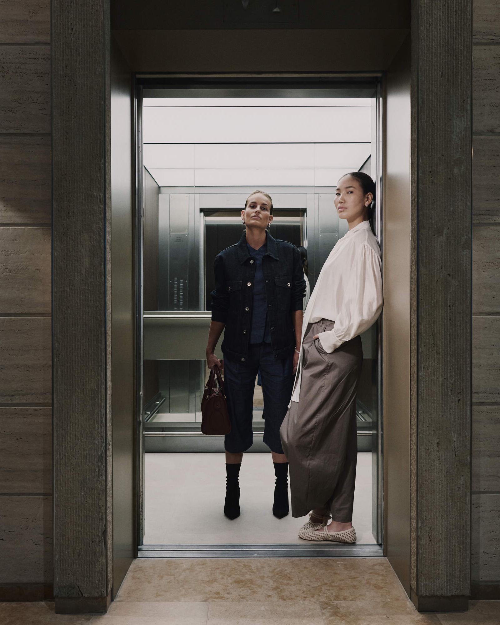 Two women stepping out of an elevator at WTC Amsterdam