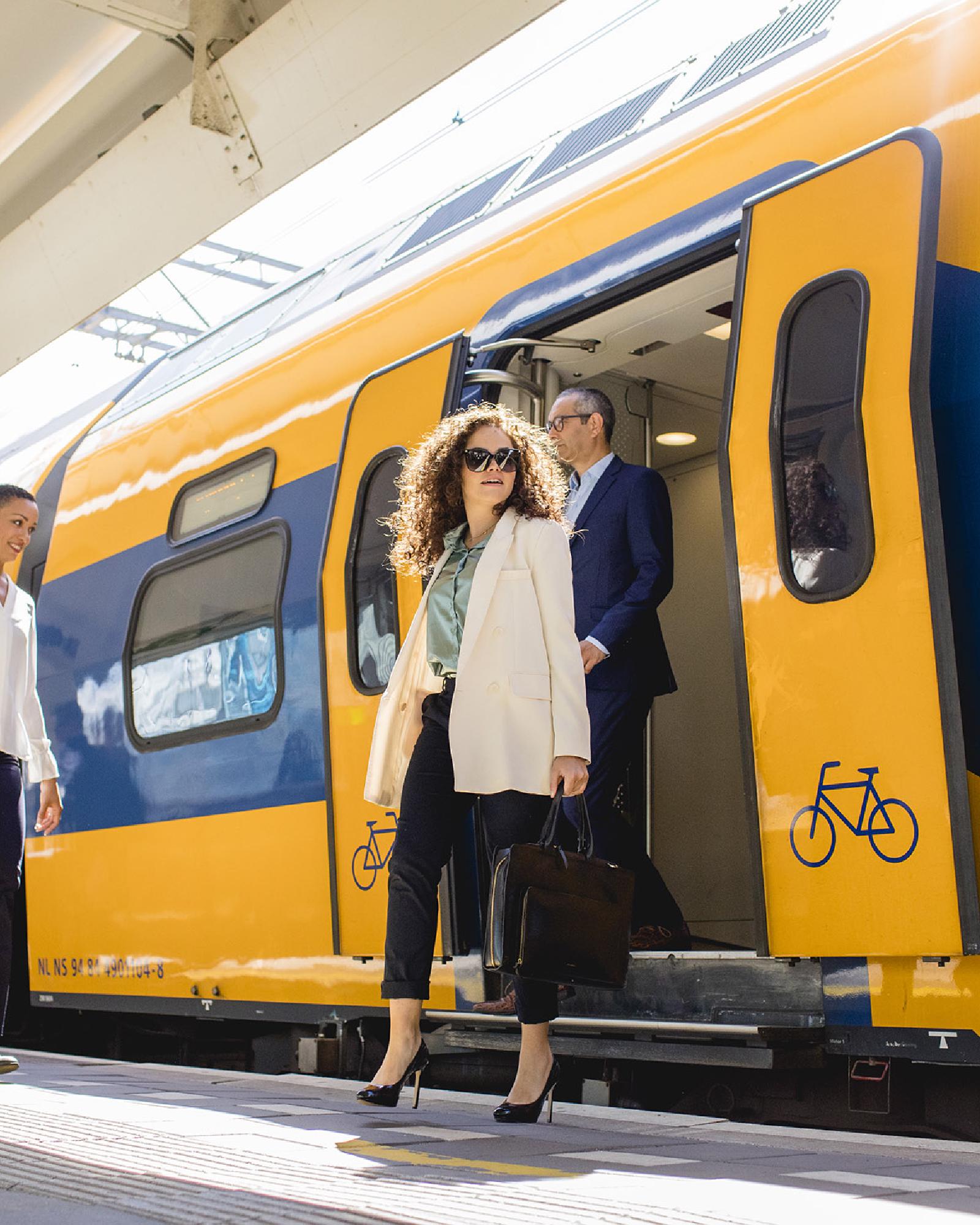 Passengers boarding a train at Amsterdam Zuid station, next to WTC Amsterdam